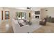 Bright living room with stone fireplace, tile flooring, open floor plan, and outdoor view through French doors at 9349 E Calle De Valle Dr, Scottsdale, AZ 85255