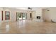 Bright living room with stone fireplace, tile flooring, open floor plan, and outdoor view through French doors at 9349 E Calle De Valle Dr, Scottsdale, AZ 85255