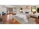 This staged main bedroom features a seating area, hardwood floors, and private patio access at 9349 E Calle De Valle Dr, Scottsdale, AZ 85255