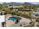 Aerial view of a private pool surrounded by desert landscaping and mountain views at 9349 E Calle De Valle Dr, Scottsdale, AZ 85255