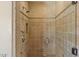 The tiled shower features a glass door, stone walls, and multiple shower heads at 9349 E Calle De Valle Dr, Scottsdale, AZ 85255