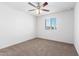 A bright bedroom featuring neutral carpet, a ceiling fan, and a window at 935 E Agua Fria Ln, Avondale, AZ 85323