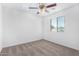 A bright bedroom featuring neutral carpet, a ceiling fan, and a window at 935 E Agua Fria Ln, Avondale, AZ 85323