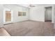 Bright bedroom features carpet, white walls, and a large window, creating a serene atmosphere at 935 E Agua Fria Ln, Avondale, AZ 85323