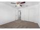 A bedroom with neutral carpet, closet, and ceiling fan at 935 E Agua Fria Ln, Avondale, AZ 85323
