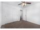 A bedroom with neutral carpet, closet, and ceiling fan at 935 E Agua Fria Ln, Avondale, AZ 85323
