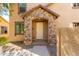 Inviting front entrance with stone pillars, neutral stucco, and a neatly maintained yard at 935 E Agua Fria Ln, Avondale, AZ 85323
