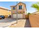 Two story house with a two-car garage and gravel landscaping at 935 E Agua Fria Ln, Avondale, AZ 85323