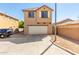 Two story house with a two-car garage and gravel landscaping at 935 E Agua Fria Ln, Avondale, AZ 85323