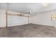 Spacious garage with a white door and overhead lighting at 935 E Agua Fria Ln, Avondale, AZ 85323
