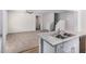 Open-concept kitchen with stone countertops, stainless sink, and access to the living room at 935 E Agua Fria Ln, Avondale, AZ 85323