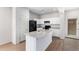 Kitchen with white cabinets and a granite-topped island, with black appliances, offering ample counter space at 935 E Agua Fria Ln, Avondale, AZ 85323
