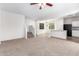 Spacious living room with carpet, flowing into kitchen and dining area, offering open-concept living at 935 E Agua Fria Ln, Avondale, AZ 85323