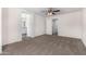 Spacious carpeted main bedroom featuring ceiling fan and ensuite access at 935 E Agua Fria Ln, Avondale, AZ 85323