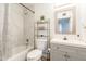 Bright bathroom features a tub with marble tiling, modern vanity and mirror, and sleek fixtures at 1001 W 19Th St, Tempe, AZ 85281
