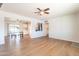 Spacious living area showcasing the wood floors, ceiling fan, and seamless flow into the dining space at 1001 W 19Th St, Tempe, AZ 85281