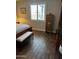 Bedroom with wood look floors, shuttered window and decorative furniture at 10704 E Twister Ave, Mesa, AZ 85212