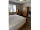 Bedroom with shuttered windows, wood-look floors, and decorative furniture at 10704 E Twister Ave, Mesa, AZ 85212