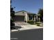 Charming single story home with a well-manicured lawn, a grey garage door, and desert landscaping at 10704 E Twister Ave, Mesa, AZ 85212