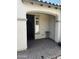 Covered front porch with brick pavers and a decorative metal security door at 10704 E Twister Ave, Mesa, AZ 85212