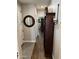 Hallway with wood-look tile floors and decorative wall mirror at 10704 E Twister Ave, Mesa, AZ 85212