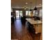 Kitchen island with seating, opening to the living room and backyard views at 10704 E Twister Ave, Mesa, AZ 85212
