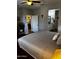 Spacious bedroom featuring warm neutral tones, wood-look flooring, and an ensuite bathroom at 10704 E Twister Ave, Mesa, AZ 85212