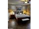 Bedroom with decorative lamps, shuttered windows and wood look floors at 10704 E Twister Ave, Mesa, AZ 85212