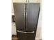 Modern kitchen refrigerator featuring a sleek black finish and stainless steel handles at 10704 E Twister Ave, Mesa, AZ 85212