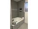 Stylish bathroom with tiled walls, a bathtub, and modern fixtures at 11028 W Crimson Ln, Avondale, AZ 85392