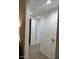 Bright hallway with light wood-look flooring and white walls at 11028 W Crimson Ln, Avondale, AZ 85392
