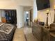 A bright main bedroom featuring a comfortable bed, vaulted ceiling, and walk-in closet at 11028 W Crimson Ln, Avondale, AZ 85392