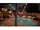 Outdoor swimming pool with lounge chairs and festive string lights at 11028 W Crimson Ln, Avondale, AZ 85392