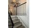 Stairway featuring modern railings, neutral colors, and access to upper levels at 11028 W Crimson Ln, Avondale, AZ 85392
