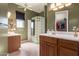 Well-lit bathroom with dual vanities, tiled flooring, and a glass block shower at 11242 E Onza Ave, Mesa, AZ 85212