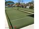 Beautiful bocce ball court with manicured green turf and landscaping for outdoor enjoyment at 11242 E Onza Ave, Mesa, AZ 85212