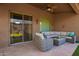 Relaxing covered patio with stone flooring and comfortable seating area at 11242 E Onza Ave, Mesa, AZ 85212