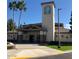 Community center's inviting entrance with a well-designed facade, palm trees, and manicured landscaping at 11242 E Onza Ave, Mesa, AZ 85212