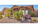 Inviting single-story home with desert landscaping featuring rock and cactus accents at 11242 E Onza Ave, Mesa, AZ 85212