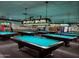 Spacious recreation center with multiple billiard tables and decorative lighting fixtures above at 11242 E Onza Ave, Mesa, AZ 85212