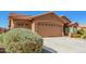 Single-story home featuring a two-car garage with a wide driveway and desert landscaping at 11242 E Onza Ave, Mesa, AZ 85212