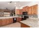 Kitchen featuring granite countertops, tiled backsplash, and wood cabinetry at 11242 E Onza Ave, Mesa, AZ 85212