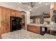 Kitchen with granite countertops, wood cabinets, and modern black appliances at 11242 E Onza Ave, Mesa, AZ 85212