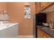 Functional laundry room with appliances, storage cabinets, and countertop space at 11242 E Onza Ave, Mesa, AZ 85212
