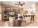 Open concept living room with full bar, tile floors, and views to the kitchen area at 11242 E Onza Ave, Mesa, AZ 85212