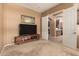 Neutral room with a TV and view of the kitchen through double doors, blending living spaces at 11242 E Onza Ave, Mesa, AZ 85212