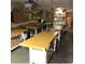 A workshop with multiple workbenches with an assortment of tools, cabinets, and storage at 11242 E Onza Ave, Mesa, AZ 85212