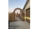 The property features a gated entrance with desert landscaping and an arched entryway at 12501 W Rosewood Dr, El Mirage, AZ 85335