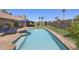 Large backyard featuring an in-ground pool, mature trees, patio, desert landscaping, privacy wall, and outdoor living spaces at 13593 N 91St Way, Scottsdale, AZ 85260