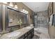 Well-lit bathroom featuring a double sink vanity with granite countertops and a shower-tub combo with tiled walls at 13593 N 91St Way, Scottsdale, AZ 85260